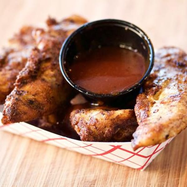 Larry J's BBQ Cafe's crispy chicken tenders with a side of barbecue dipping sauce.